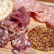 Close-up view of a charcuterie board with meat, bread, and mustard